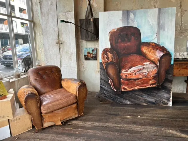 The Le Labo armchair beside its painted portrait