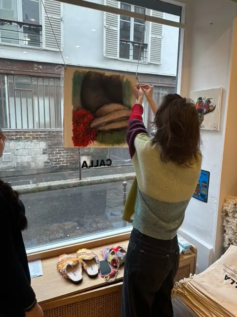 Hanging the work in the Calla Paris boutique