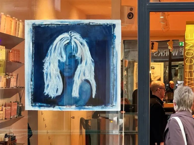 Visitors viewing the blue portrait in the Feel Soho window